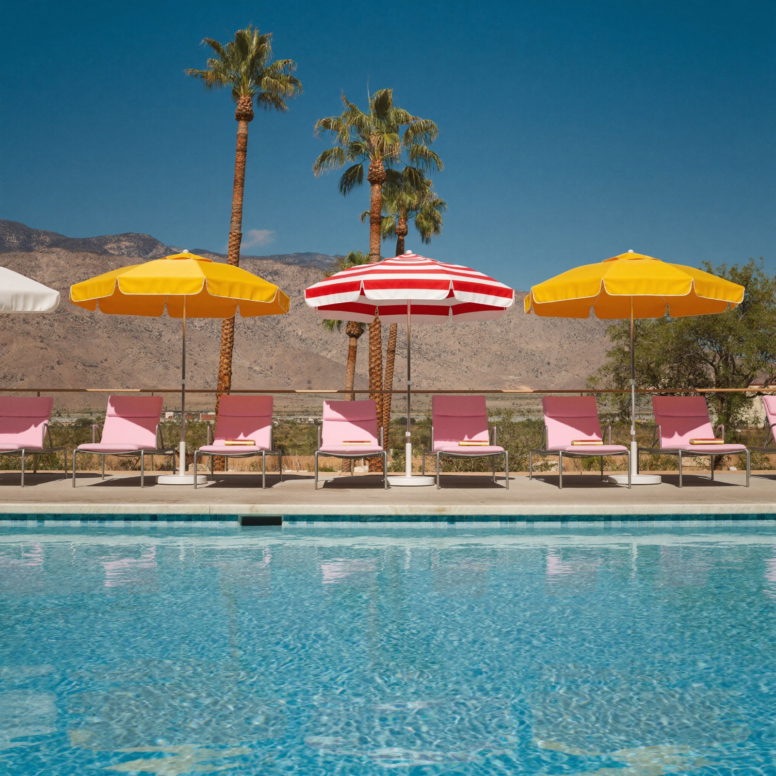 Sun loungers and parasols by a hotel pool